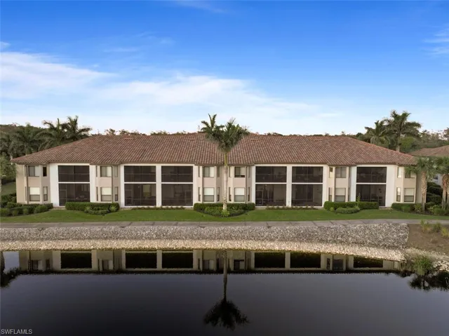 Rear view of house with a lawn