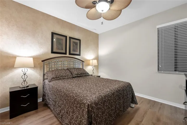 Bedroom with hardwood / wood-style floors and ceiling fan