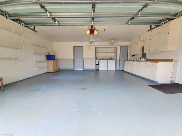 Garage featuring washer and clothes dryer and a garage door opener