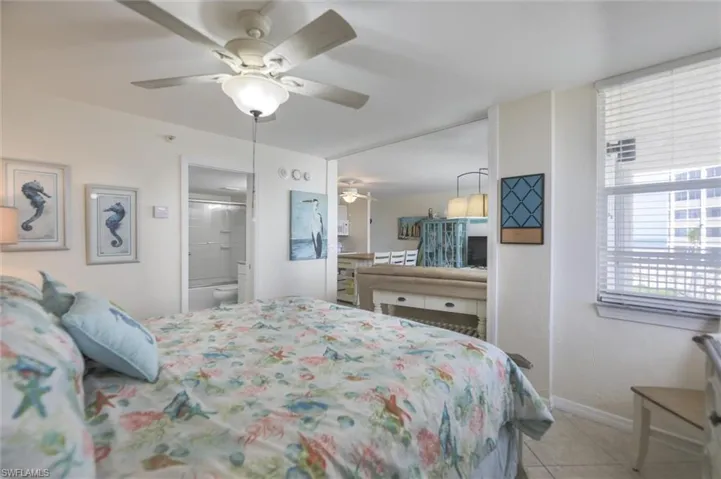 Living area featuring ceiling fan and light tile patterned flooring