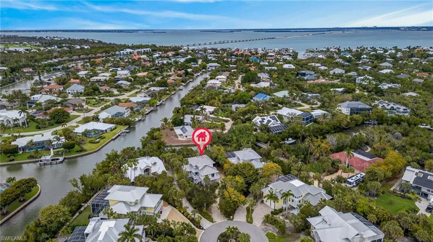 Aerial perspective of suburban area featuring a large body of water