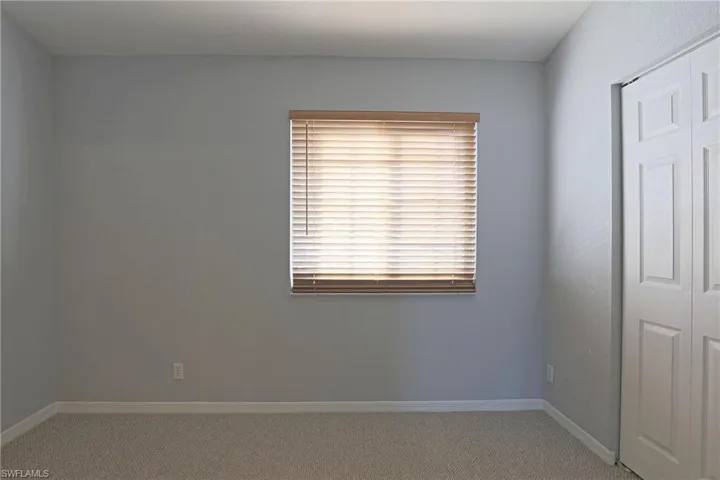 Unfurnished bedroom featuring carpet and a closet