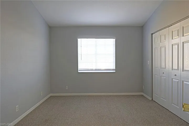 Unfurnished bedroom featuring carpet floors and a closet