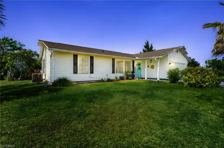 Ranch-style home featuring a front yard