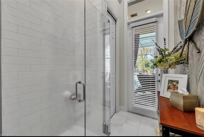 Full bath featuring a shower stall