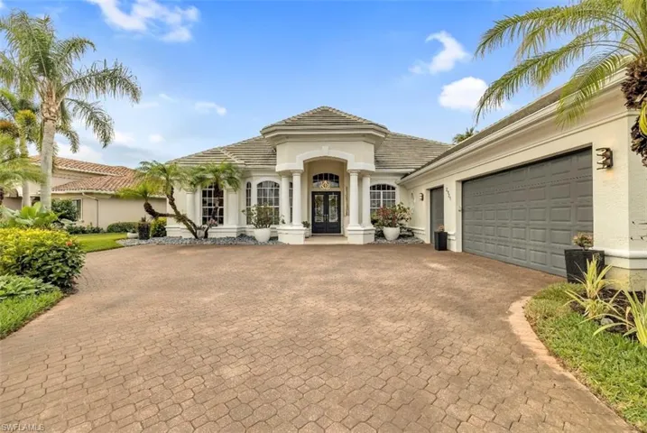 Mediterranean / spanish house with stucco siding, decorative driveway, a garage, french doors, and a tile roof