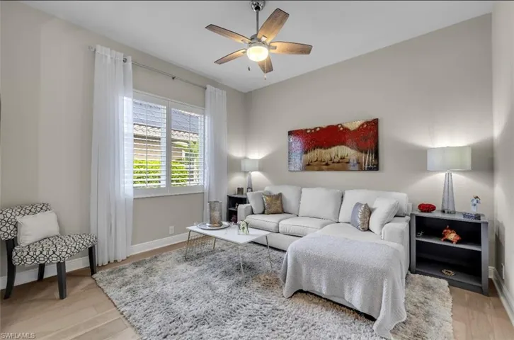 Living room featuring light wood finished floors and ceiling fan