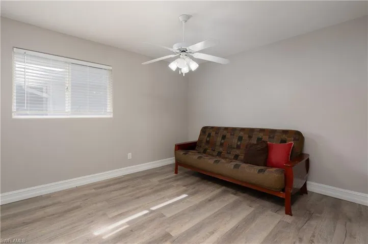 Living area with ceiling fan and light wood-type flooring