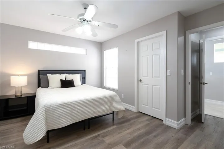 Bedroom featuring ceiling fan and dark hardwood / wood-style floors