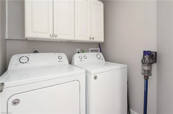 Laundry room with washer and dryer and cabinets