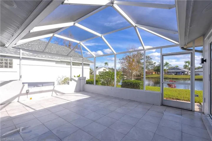 View of patio / terrace featuring a water view and a lanai