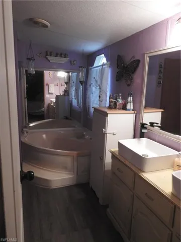Bathroom with sink, a textured ceiling, and hardwood / wood-style flooring