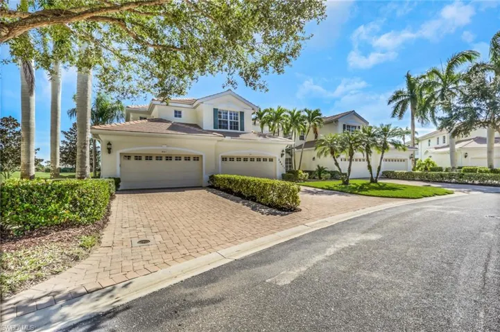View of front of home with decorative driveway, stucco siding, and a tiled roof