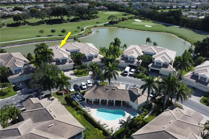 Aerial view of residential area with a golf club and a nearby body of water