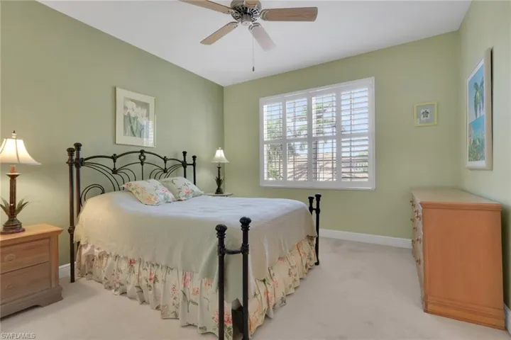 Carpeted bedroom featuring baseboards and ceiling fan