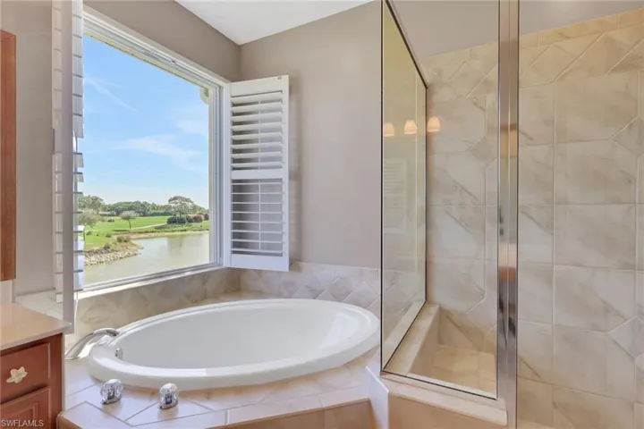 Full bathroom with a bath, a stall shower, and vanity