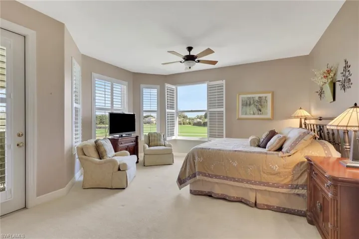 Bedroom with light carpet, access to outside, and a ceiling fan