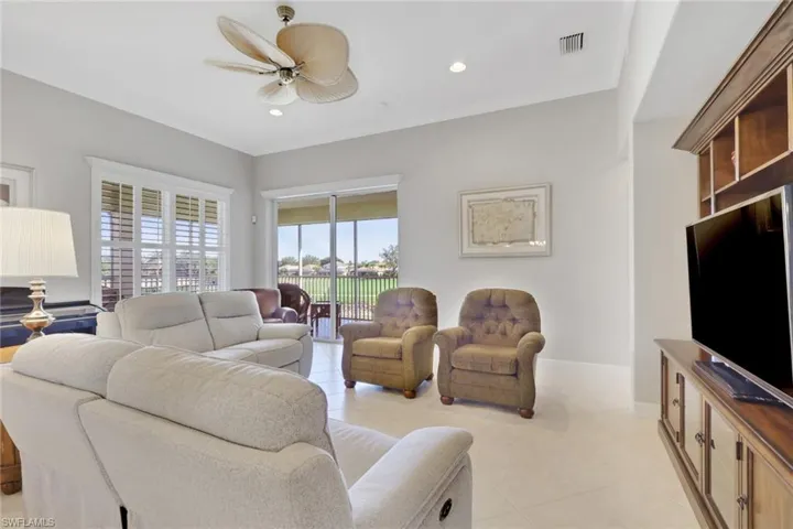 Living area featuring a ceiling fan, light tile patterned floors, recessed lighting, and crown molding