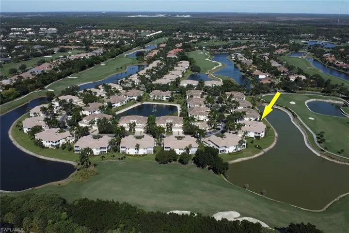 Aerial view of property and surrounding area featuring nearby suburban area and a golf club