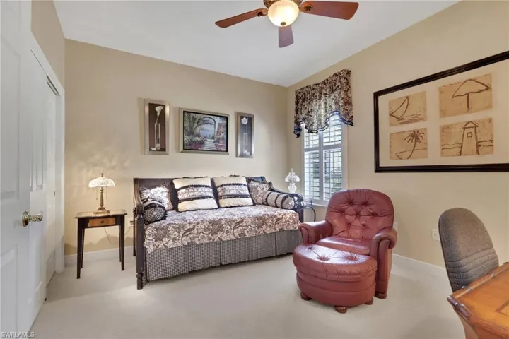 Carpeted bedroom with baseboards and a ceiling fan