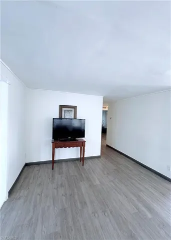 Living area with light wood-type flooring and baseboards