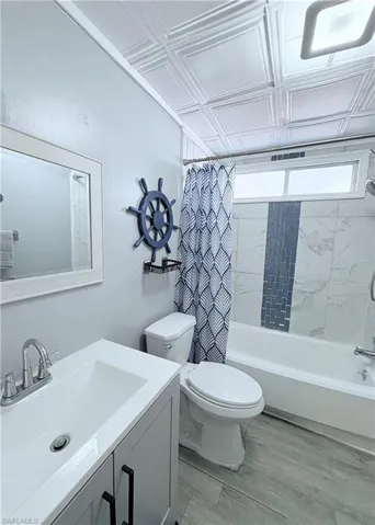 Full bathroom with shower / bath combo and vanity