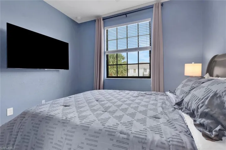 Room featuring a multi-pane window with black frame and horizontal blinds