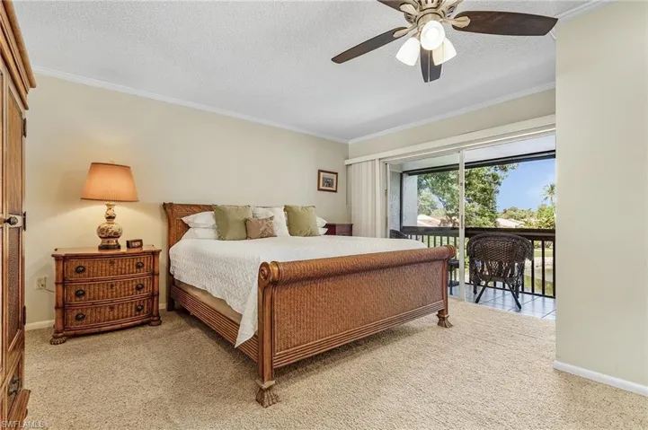 Spacious VIP Bedroom with screened-in balcony - staged. Furniture in the photo is not currently in place, but like minded, King bedroom set.