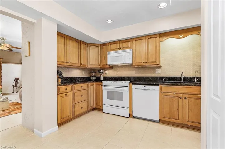Kitchen with Granite, Maple Cabinets and Flex room entrance.