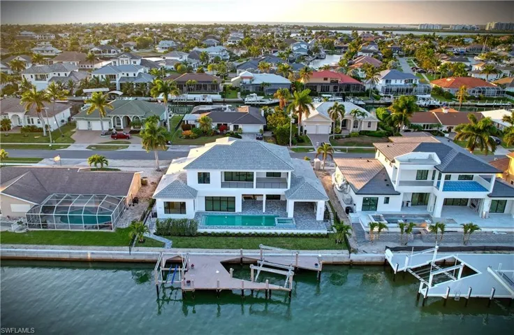 Aerial view of residential area featuring a nearby body of water