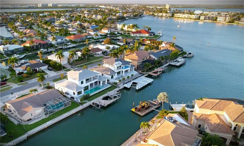 Aerial view at dusk of a water view and a residential view