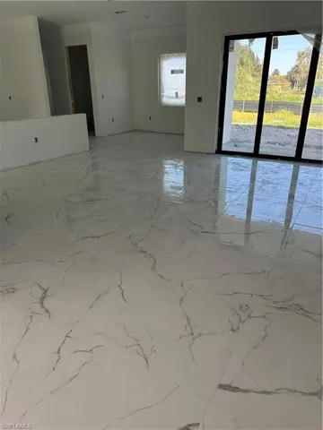 Unfurnished room with light marble finish flooring