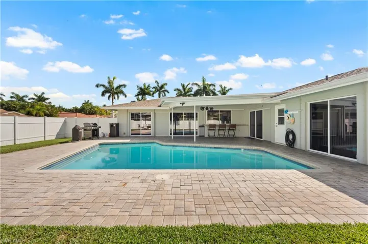 View of pool with a grill and a patio