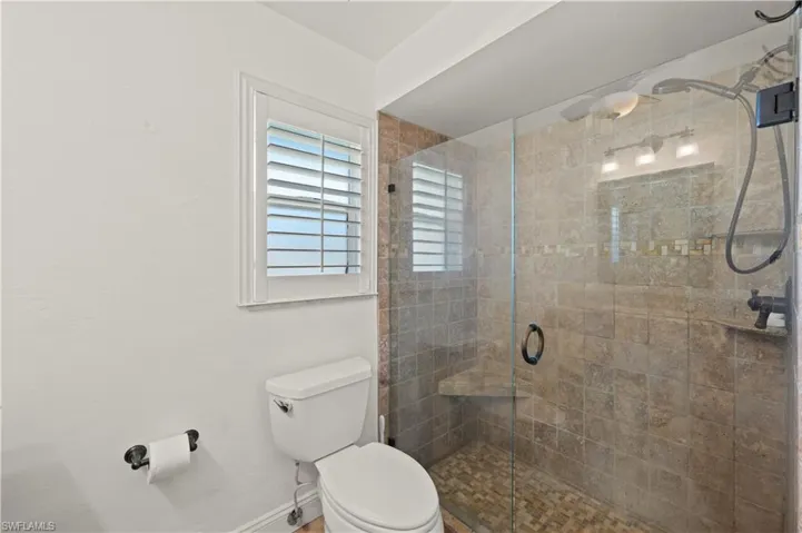 Bathroom with an enclosed shower and toilet