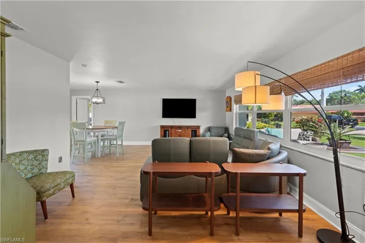 Living room featuring a chandelier and light wood-type flooring