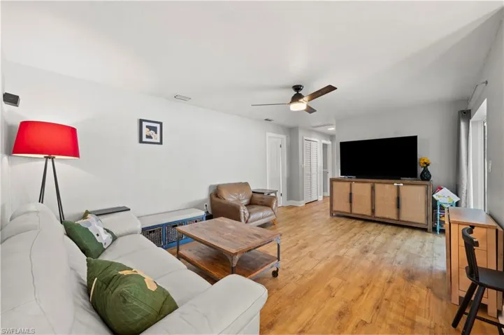 Living room featuring light wood-type flooring and ceiling fan