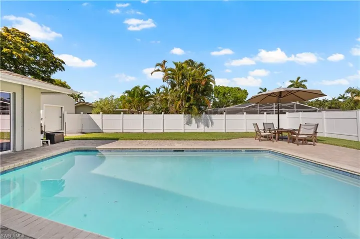 View of pool featuring a patio and a yard