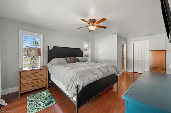 Bedroom featuring dark hardwood / wood-style floors and ceiling fan