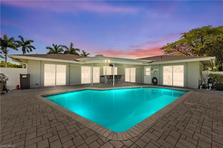 Pool at dusk with a patio