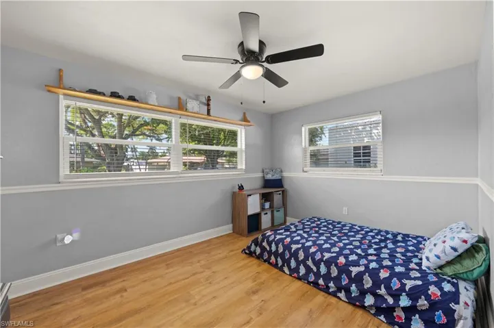 Bedroom featuring ceiling fan and light wood-type flooring