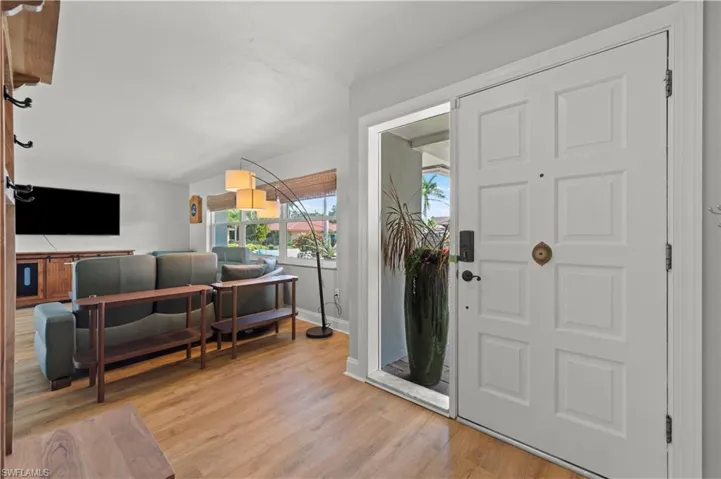 Entrance foyer with light wood-type flooring