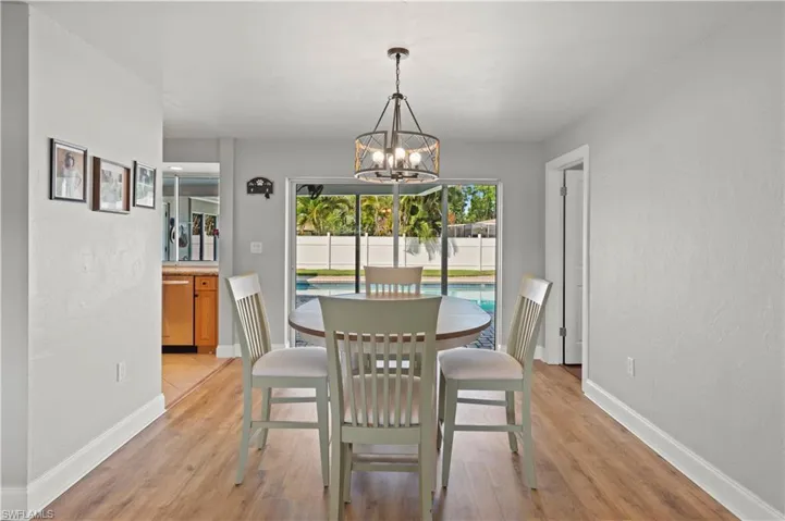 Dining space featuring a notable chandelier and light wood-type flooring