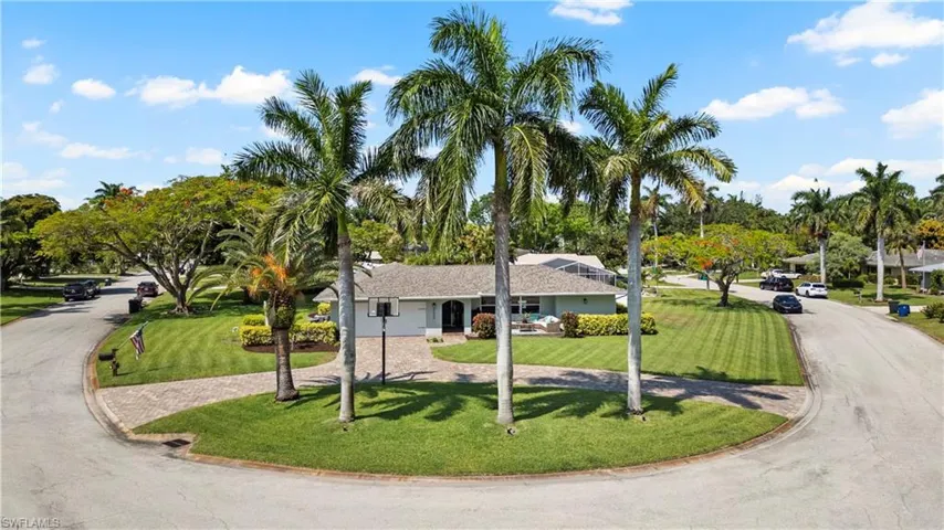 View of front of home featuring a garage and a yard