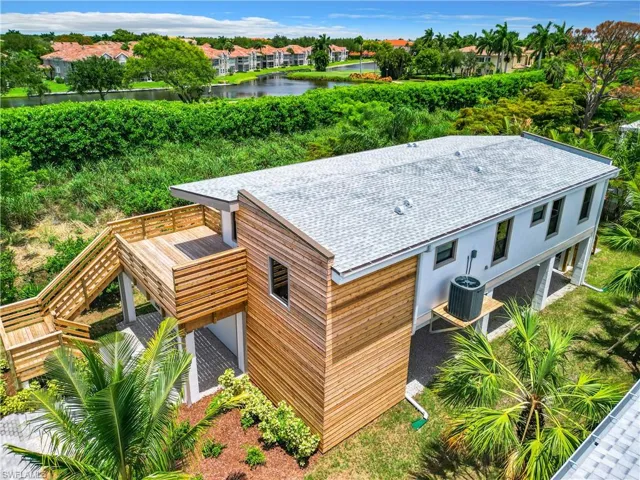 Birds eye view of property with a water view