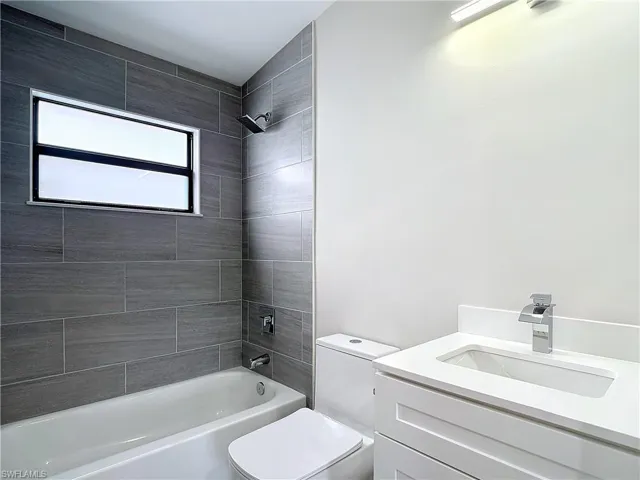 Full bath with toilet, shower / bathing tub combination, and vanity