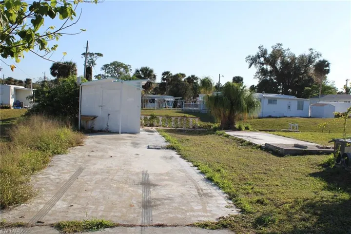 View of yard featuring a storage unit