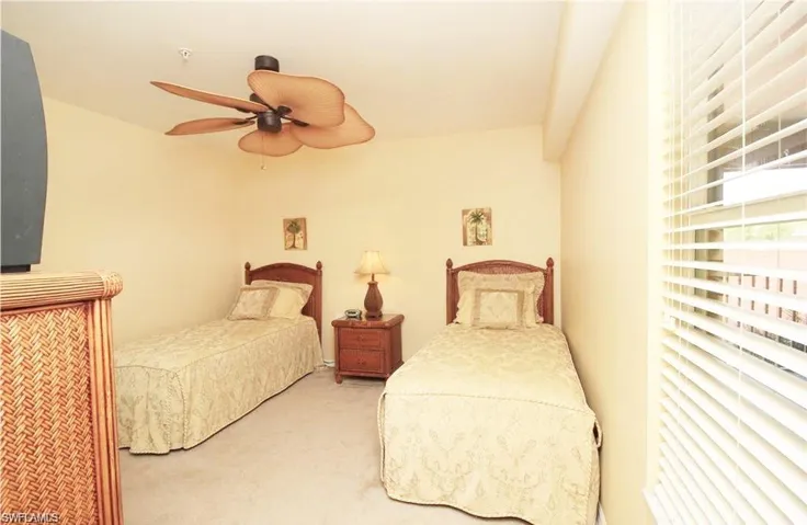 Carpeted bedroom with ceiling fan