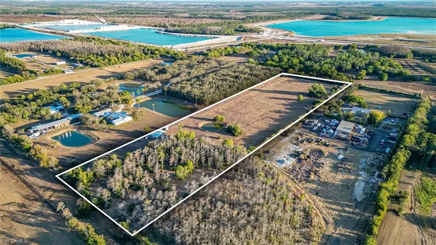 Aerial view of property's location featuring property parcel outlined, a large body of water, and extensive farmland