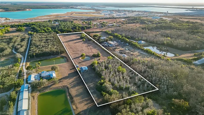 View of rural area with a large body of water and property boundaries highlighted