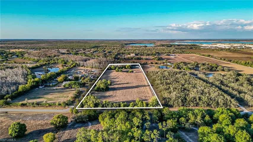 View of rural area featuring property boundaries highlighted and a nearby body of water
